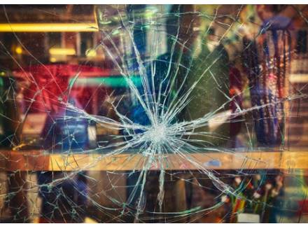 A close-up of a shattered glass window